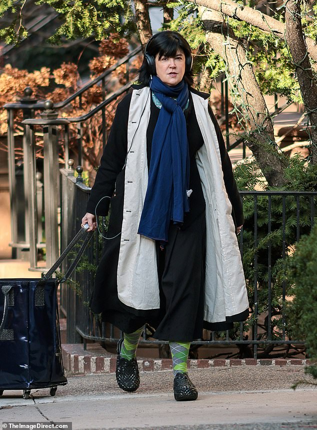 The viewer was bundled up for her day in Manhattan as the temperature plummets at the start of winter.