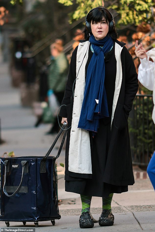 The cute girl next door had her black hair down and flattering makeup. Cates looked much younger than his 61 years. And it was a little difficult to recognize her. Phoebe was pulling a black and blue stroller. She was on the Upper East Side of New York.