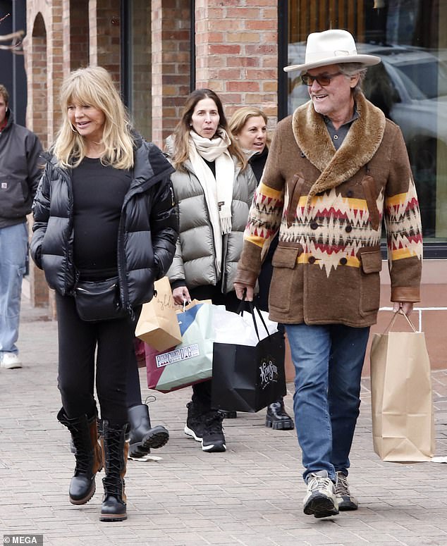 Kurt looked ready for winter in a brown wool double-breasted coat with a furry lapel, paired with blue jeans and taupe walking shoes.