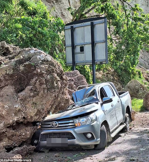 Huge boulders crushed and blocked roads in landslides after the quake toppled buildings and killed 12 people.