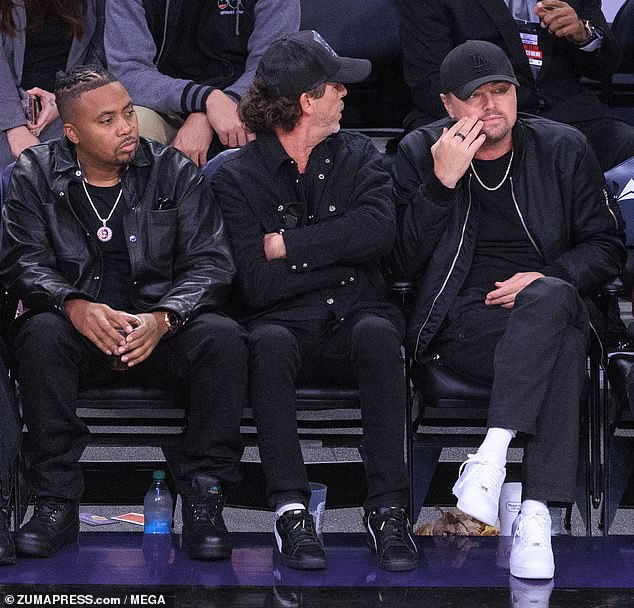 Rapper Nas (left) was also in attendance and chose a head-to-toe black outfit.