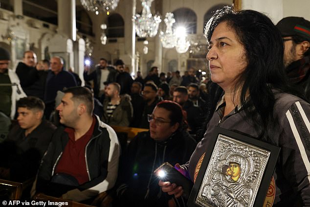 Christian faithful organize a sit-in inside the Mariamite Church in Damascus in the early hours of December 24, 2024.