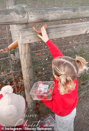 The adorable youngsters wore matching red sweaters that read: 