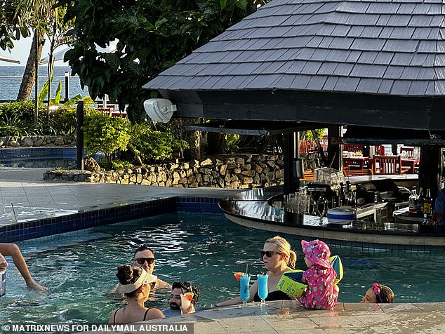 Five of the victims have since been discharged, including a mother and daughter from Sydney who returned home on Monday night (pictured: tourists could be seen enjoying drinks at the pool bar on Monday).