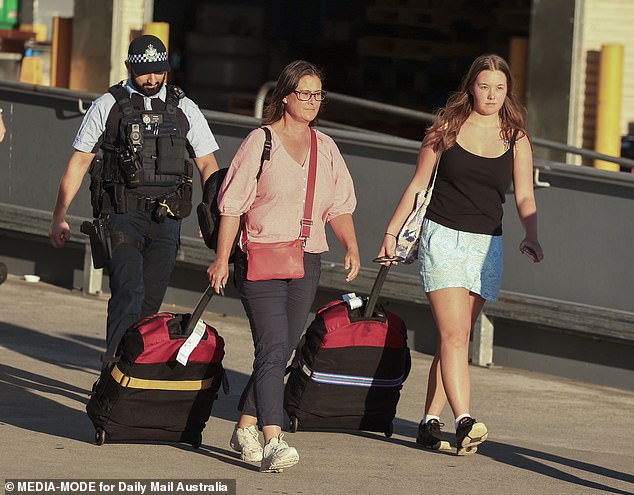 Tanya Sandoe, 56, and her daughter Georgia Sandoe-Simpson, 19, are pictured arriving home Dec. 16 after also being hospitalized for the mass poisoning.