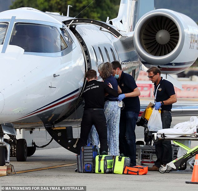 The woman was helped up and down the plane's stairs at both ends of her trip Wednesday.