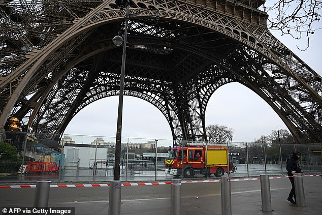 This photograph shows firefighters in their vehicle parked at the foot of the Eiffel Tower, where a fire was reported in Paris, on December 24.