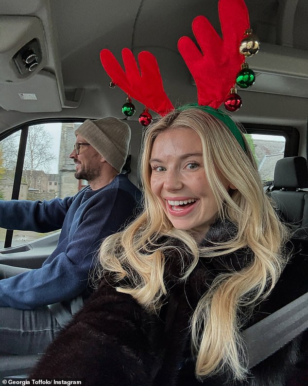 The former I'm A Celebrity star sported a pair of ornament-covered antlers for the party.