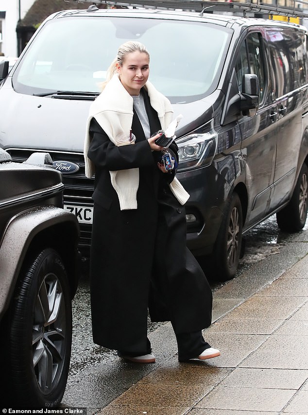 While walking through the rainy town, Molly-Mae was seen juggling a Costa coffee, a snack, her phone, a camera and her keys between her two hands.