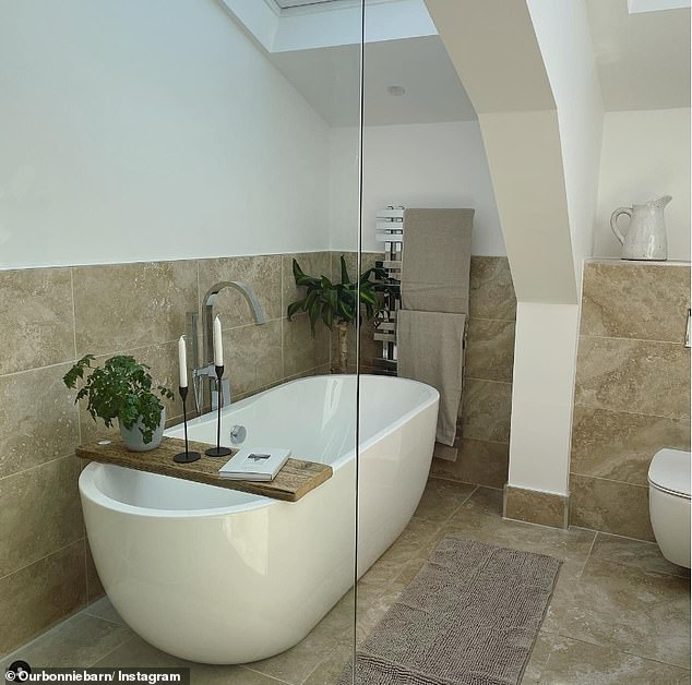 The former Gogglebox star also showed off her luxurious bathroom on social media, which includes a freestanding white bathtub under a skylight, tiled floor and walls and is filled with tropical houseplants.