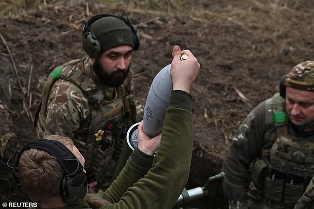 Members of the Consolidated 'Khyzhak' (Predator) Brigade of the Ukrainian Patrol Police Department place a projectile in a mortar as they fire on Russian troops in their position on a front line near the city of Toretsk, amid the attack from Russia to Ukraine, in Donetsk. region, Ukraine December 20, 2024