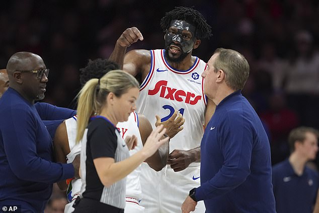 An enraged Joel Embiid charged the referees after the ejection and was restrained.