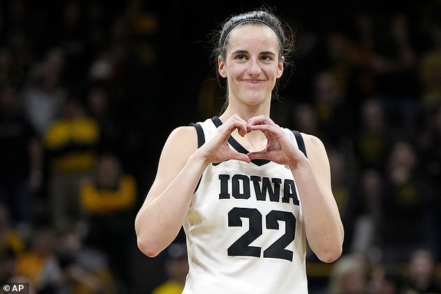 Clark gestures with his heart after the NCAA college basketball game against Michigan.