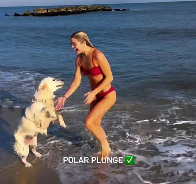 Dunne's golden retriever Roux was at the beach and came to meet the Tigers star in the water