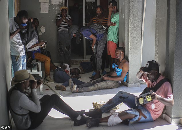 Journalists are left injured after being shot by armed gangs at the General Hospital in Port-au-Prince