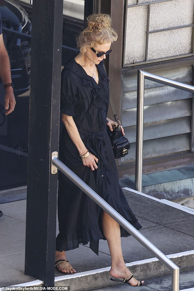 Stepping out for the Christmas Day service, Nicole cut an elegant figure in a black dress with a ruffled neckline, which she paired with dark sandals.