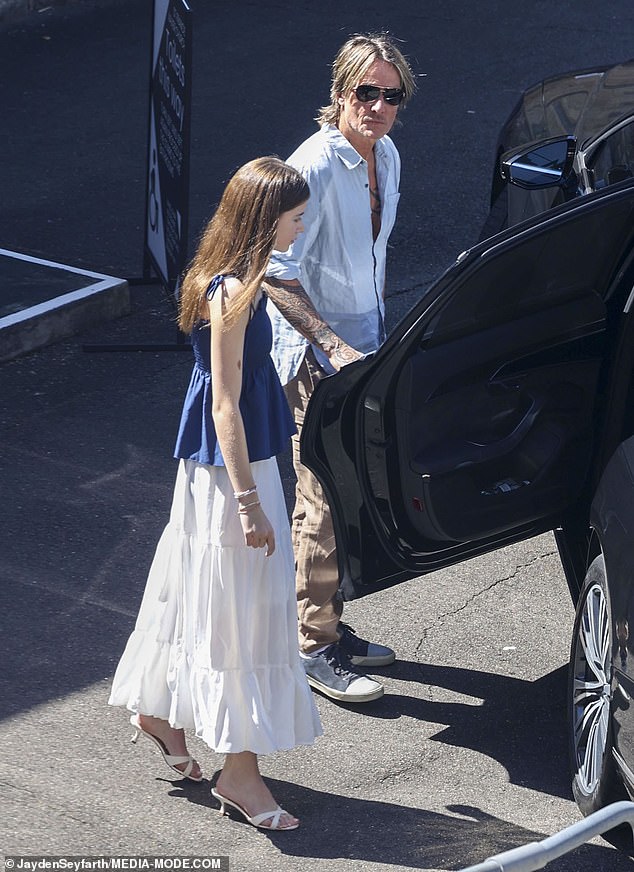 Keith was seen holding the car door open for his youngest daughter, Faith, as they left the church to continue the Christmas celebrations.