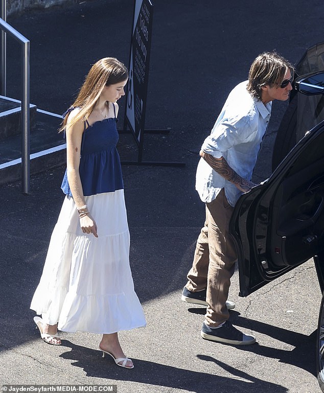 Faith wore a blue and white dress and high-heeled sandals to the Christmas Day church service.