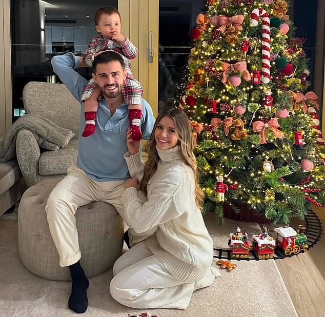 Bernardo Silva sat in front of his tree with his partner Inés Tomaz and his daughter Carlota