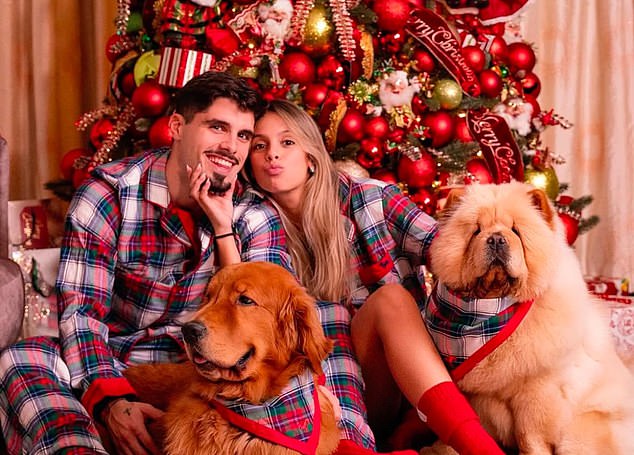 Pedro Neto was all smiles with his partner Carolina Silva and their two dogs.