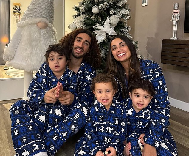 Marc Cucurella's family sat in front of the tree - and a large gonk - wearing matching blue pajamas