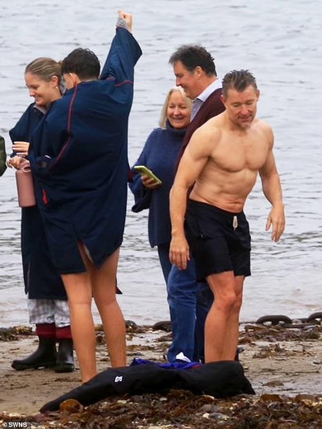 And as he slipped into his navy swimsuit, the presenter showed off his taut abs and chiseled chest.