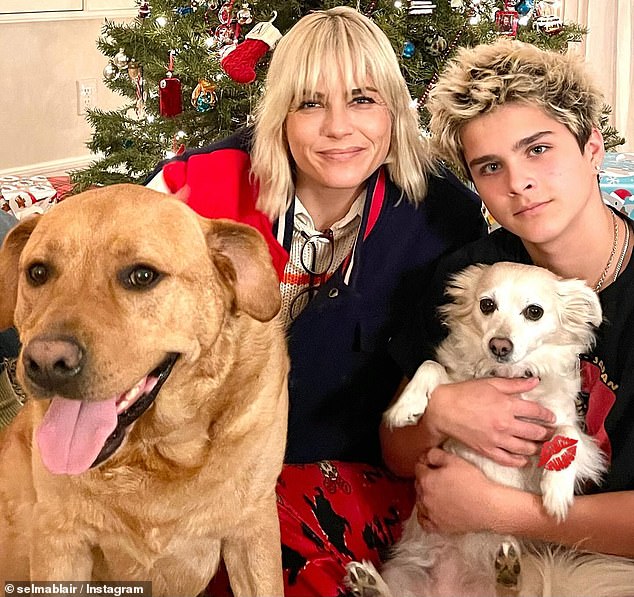 Meanwhile, Selma Blair was photographed at the foot of her tree with her dogs and her son Arthur Bleick, 13, whom she had with her former fashion designer Jason Bleick.