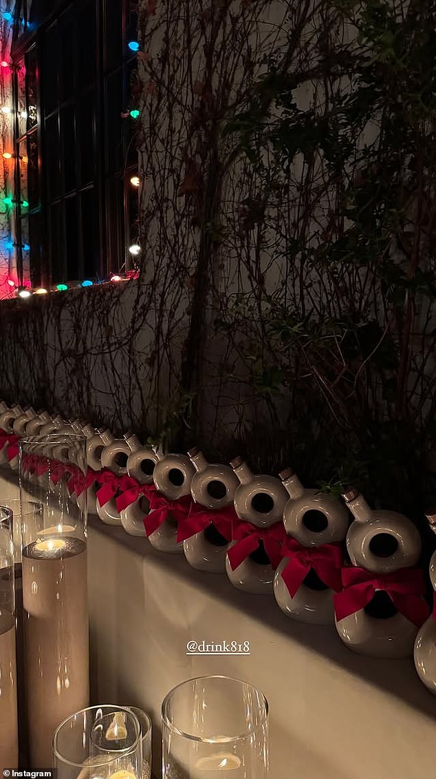 The model also shared a photo of a wall full of bottles of her reserve tequila, warmly illuminated by tall candles and strings of colorful Christmas lights.