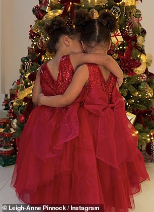 The little twins are captured in a series of shots from behind, hugging each other