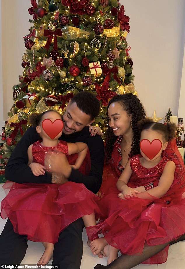 Leigh-Anne and the footballer put on a very radiant sight gently cradling their daughters as they celebrated the Christmas festivities.