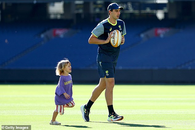 Australian captain Pat Cummins is pictured running at the Melbourne Cricket Ground with his son Alfie on Christmas Day.