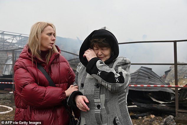 A local resident reacts near her neighbor's house, which was destroyed in a drone strike in Kharkov on December 25, 2024, during the Russian invasion of Ukraine