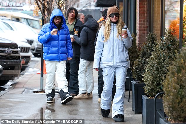 The duo were seen holding hands and drinking a hot cup of coffee as they bundled up to combat the freezing temperatures.