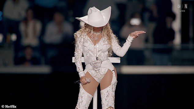 The Texas singer raised her eyebrows with a gun gesture just as a large 'Bang' banner was unfurled beneath her platform, a move that is illegal for NFL players to make on the field.