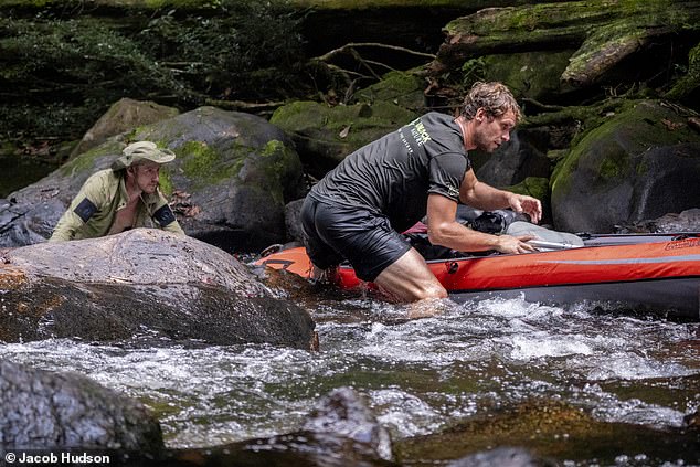 After six days of grueling work, the team was relieved to come across the source of the Coppename River. Here they can be seen navigating the difficult terrain with their kayaks.