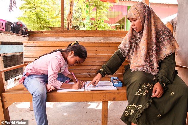 Khairani is pictured with her daughter Alifa in 2014, who was around seven years old at the time of this photograph.