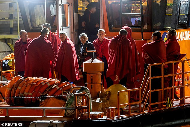 Survivors of the sinking of the Russian cargo ship Ursa Major stand on the deck of a Spanish Maritime Rescue ship upon arrival at the port of Cartagena, Spain, December 23, 2024.