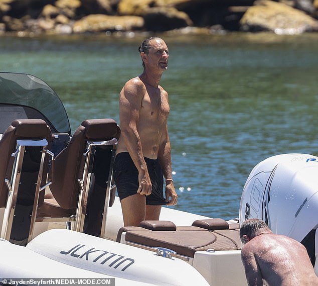 Justin showed off his muscular body while wearing black shorts with no shirt as he welcomed friends on his speedboat for the Boxing Day festivities.