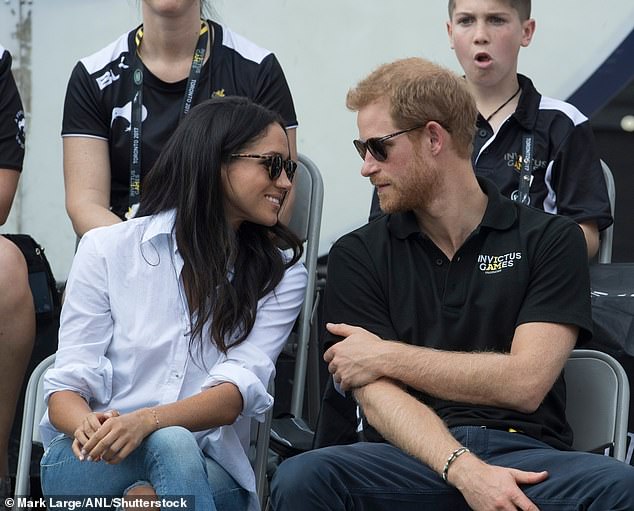 Meghan bowing as Harry speaks during the event in Toronto in 2017.