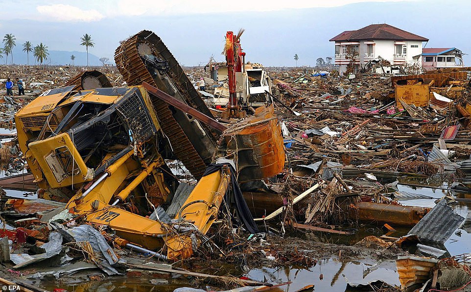 The wreck of an excavator amid rubble in Banda Aceh, Indonesia, on January 10, 2005