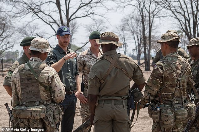 Prince Harry (pictured with armed rangers) was president of African Parks for six years until he moved to the board last year