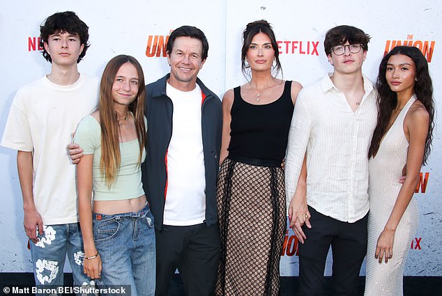 Mark and Rhea photographed with three of their four children in August, plus their son's girlfriend (far right)