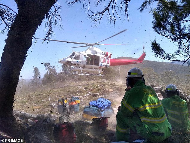 A helicopter is seen on its way to fight fires in the Grampians National Park