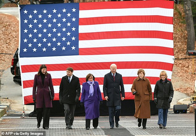 U.S. President Joe Biden (C) flanked by Senator Jeanne Shaheen (D-NH) (2nd from left), Senator Maggie Hassan (D-NH) (L), Representative Annie Kuster (D-NH) (3rd from left), Representative Chris Pappas (D-NH) (2nd from left) and New Hampshire Department of Transportation Commissioner Victoria Sheehan (L) tour the NH 175 Bridge over the Pemigewasset River in Woodstock, New Hampshire on November 16, 2021