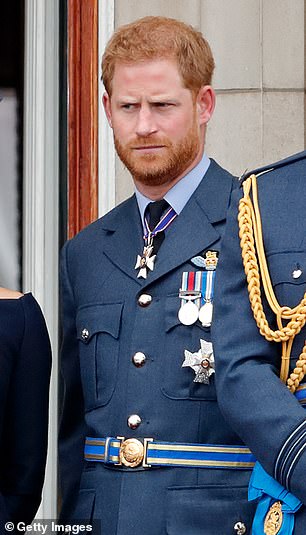 Prince Harry photographed in 2018 wearing full military attire with the Duchess of Sussex and Prince William at Buckingham Palace.