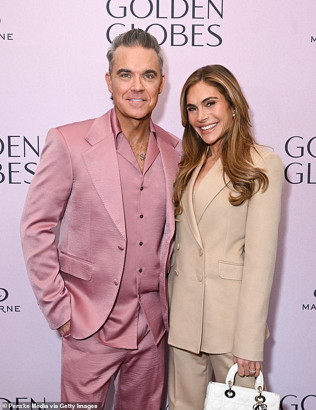 Everyone doesn't know what the fuck they're doing or how to do it. It's the luck of the algorithm,' he said. 'My algorithm thinks I'm a menopausal gay Republican. Robbie is pictured with his wife Ayda Field.