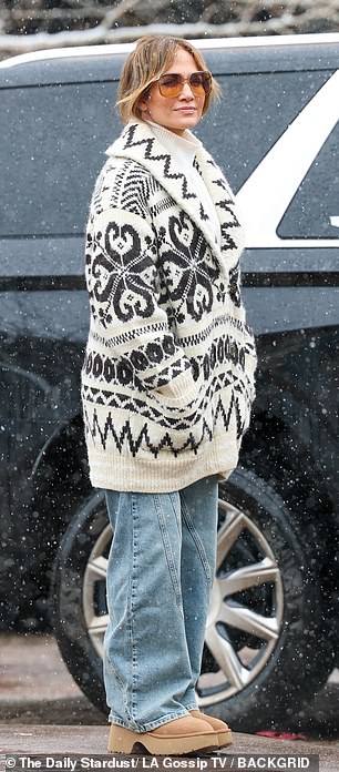 She also wore a white knit turtleneck, blue wide-leg jeans, and Timberland-style ankle boots.