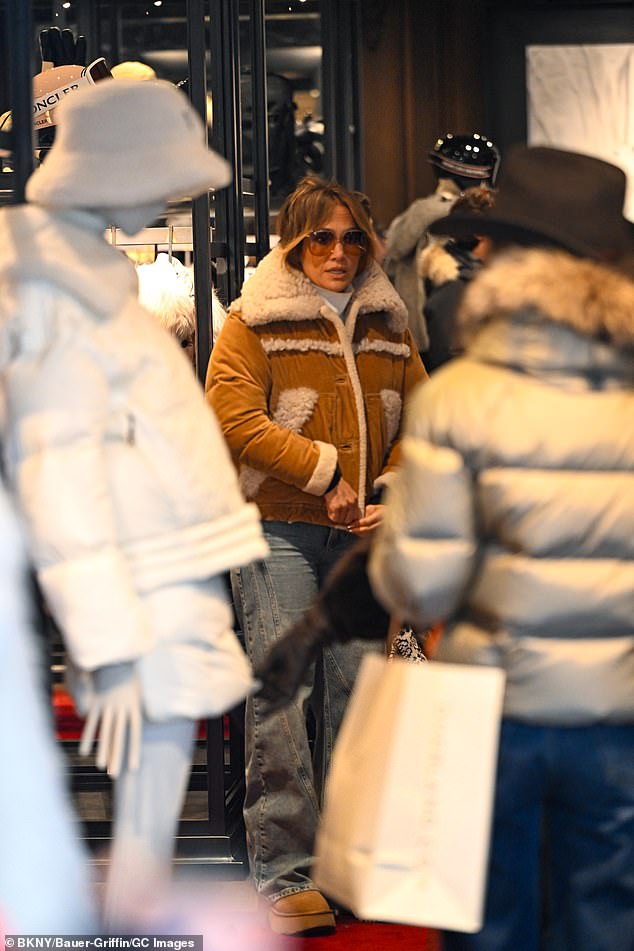 Lopez walked into a winter clothing boutique to try on a brown coat with a shearling collar.