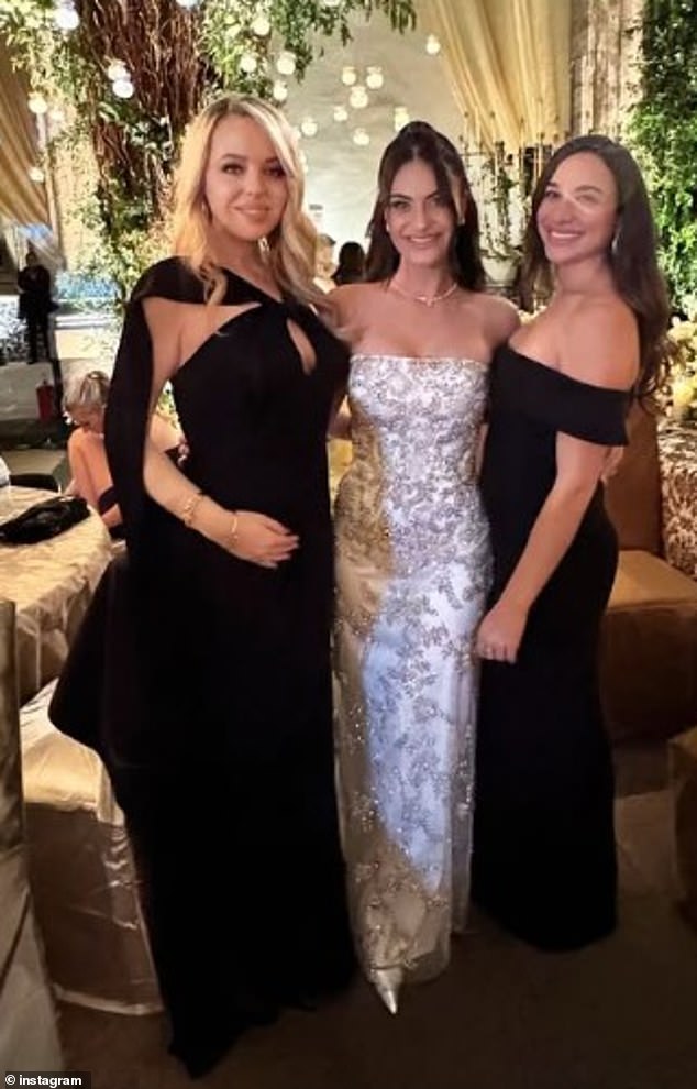 She showed off her pregnant belly in a tight, floor-length black dress, which contained a cutout in the chest area and a long, flowing piece of fabric from her shoulders.