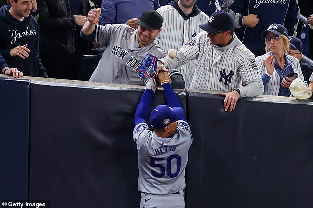 Two Yankees fans ripped the ball out of his hand after Betts caught a Gleyber Torres pop-up